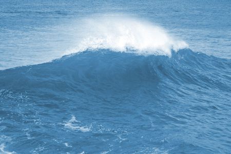 Big wave with sea foam and blue water