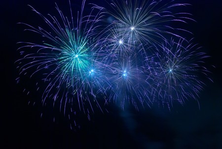 Blue fireworks on the black sky backgroundの写真素材
