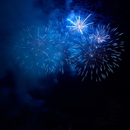 Blue fireworks on the black sky backgroundの写真素材