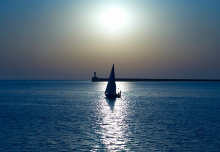 Sail boat against sea sunset. Blue marine landscape.の写真素材
