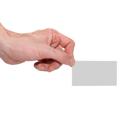 Gray card blank in a hand isolated on white.の写真素材