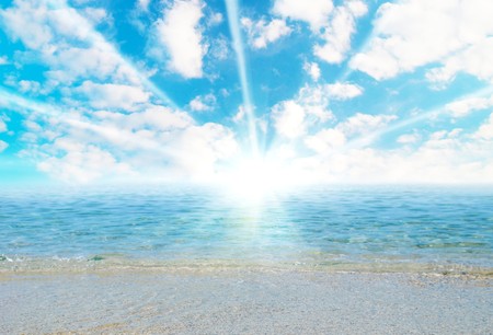 Tropical sand beach with waves and cloudscape.の写真素材