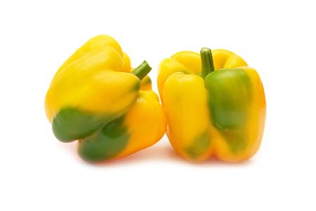 Two yellow peppers paprica (capsicum frutescens) isolated on white backgroundの写真素材