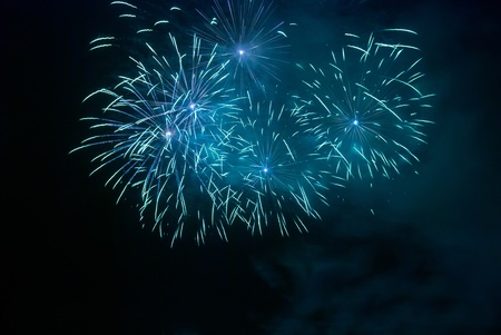 Blue fireworks on the black sky backgroundの写真素材