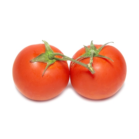 Two red tomatoes with water drops isolated on white backgroundの写真素材