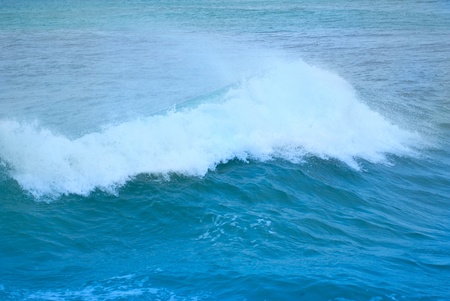 Big wave with sea foam and blue waterの写真素材