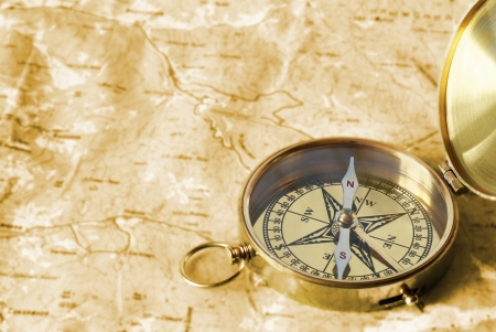 Ancient compass on the grunge old map の写真素材