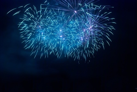 Blue fireworks on the black sky backgroundの写真素材