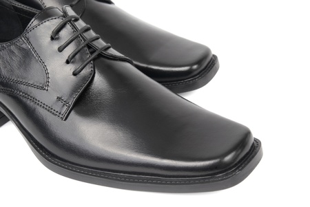 Pair of man's black shoes isolated on white backgroundの写真素材