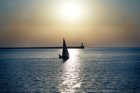 Sail boat against sea sunset. Blue marine landscape.の写真素材