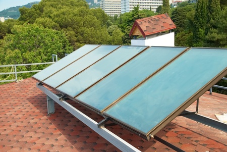 Solar water heating system on the red roof. Gelio panels.の写真素材