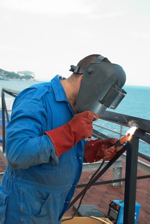 Welder at the factory working with metal constructionの写真素材