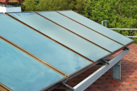 Solar water heating system on the red roof. Gelio panels.の写真素材