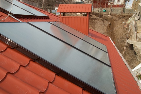 Solar water heating system on the red roof. Gelio panels.の写真素材