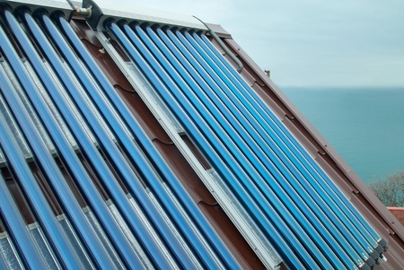 Vacuum solar water heating system on the house roof の写真素材