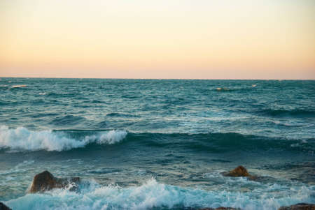 Beautiful sunset above the stormy winter seaの写真素材