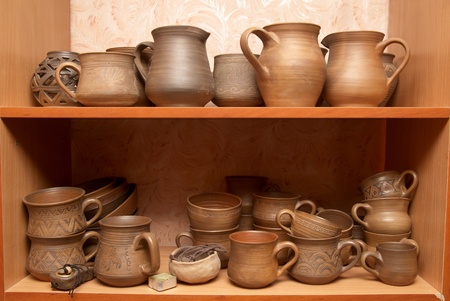 Many handmade old clay pots on the shelf.の写真素材