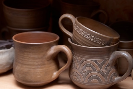 Many handmade old clay pots on the shelf.の写真素材