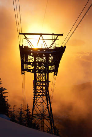Sunset in the winter forest. Silhouette of the cable rail. Vancouver, Seymour mountainの写真素材