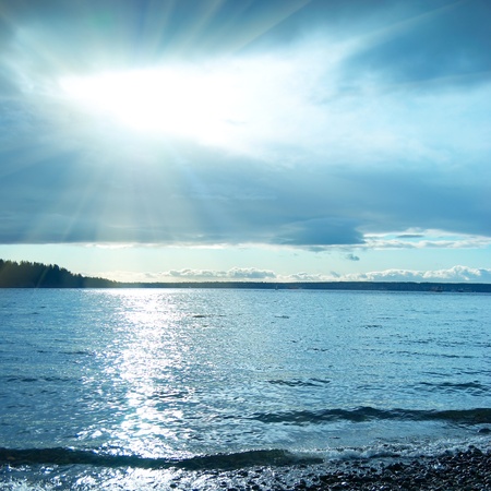Blue sunset on the sea. Coastline and beautiful cloudscape.の写真素材