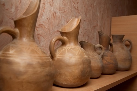 Many handmade old clay pots on the shelf.の写真素材