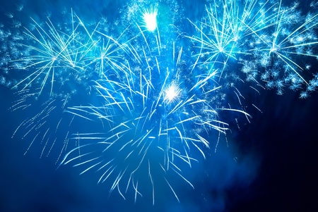 Blue colorful fireworks on the black sky background. Holiday celebration.の写真素材