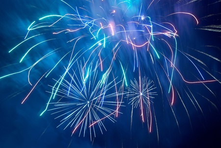 Blue colorful fireworks on the black sky background. Holiday celebration.の写真素材