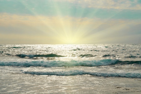 Water, waves and clouds. Sunset above the sea