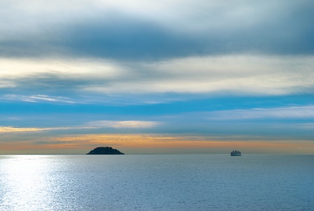 Small island in the sea. Sunset above the oceanの写真素材