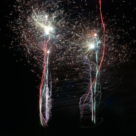 Blue colorful fireworks on the black sky background. Holiday celebration.の写真素材