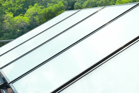 Solar water heating system on the red roof. Gelio panels.の写真素材
