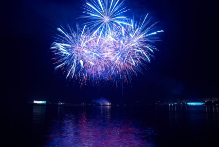 Colorful holiday fireworks on the black sky background の写真素材