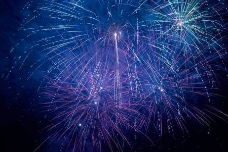 Blue colorful holiday fireworks on the black sky background.の写真素材