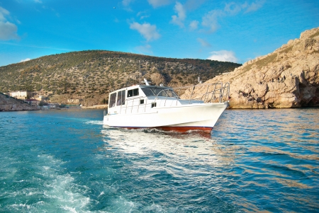 Motor boat cruising the sea near coast  Seascape の写真素材