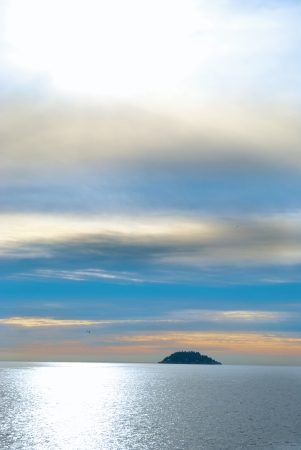 Small island in the sea. Sunset above the oceanの写真素材