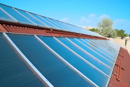 Solar water heating system on the red roof. Gelio panels.の写真素材