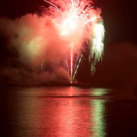 Red colorful fireworks on the black sky background  Holiday celebration の写真素材