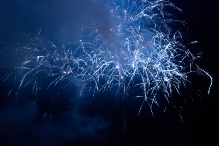 Blue colorful holiday fireworks on the black sky background.の写真素材
