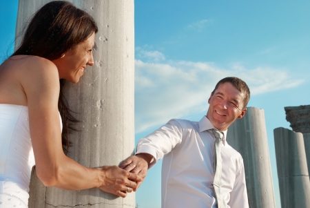 Beautiful wedding couple- bride and groom near greece column in the ancient cityの写真素材
