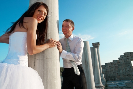 Beautiful wedding couple- bride and groom near greece column in the ancient cityの写真素材