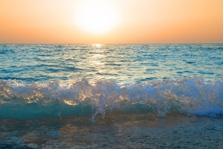 Sunset above the sea. Big sun and wavesの写真素材