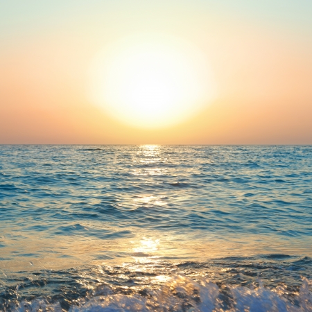 Sunset above the sea. Big sun and wavesの写真素材