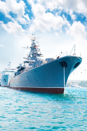 Military navy ship in the bay against blue skyの写真素材