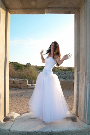 Beautiful bride in the white dress The greece ancient doorの写真素材