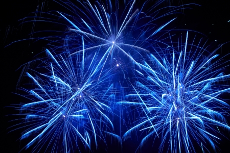 Blue colorful fireworks on the black sky backgroundの写真素材