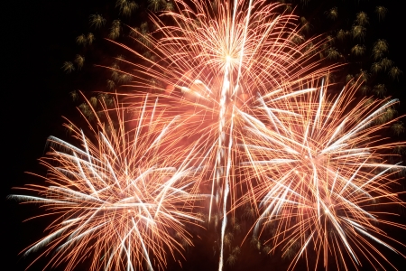 Red colorful holiday fireworks on the black sky background.の写真素材