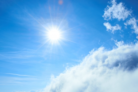Beautiful blue sky with sun and cloudsの写真素材