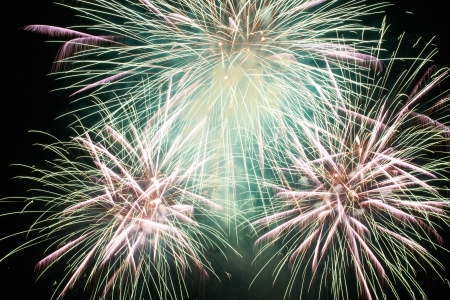 Red colorful holiday fireworks on the black sky background.の写真素材