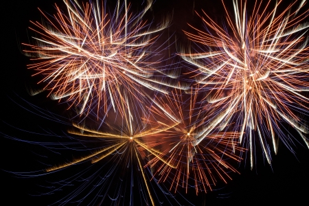 Red colorful holiday fireworks on the black sky background.の写真素材