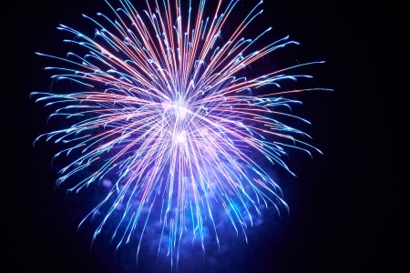 Blue colorful fireworks on the black sky backgroundの写真素材